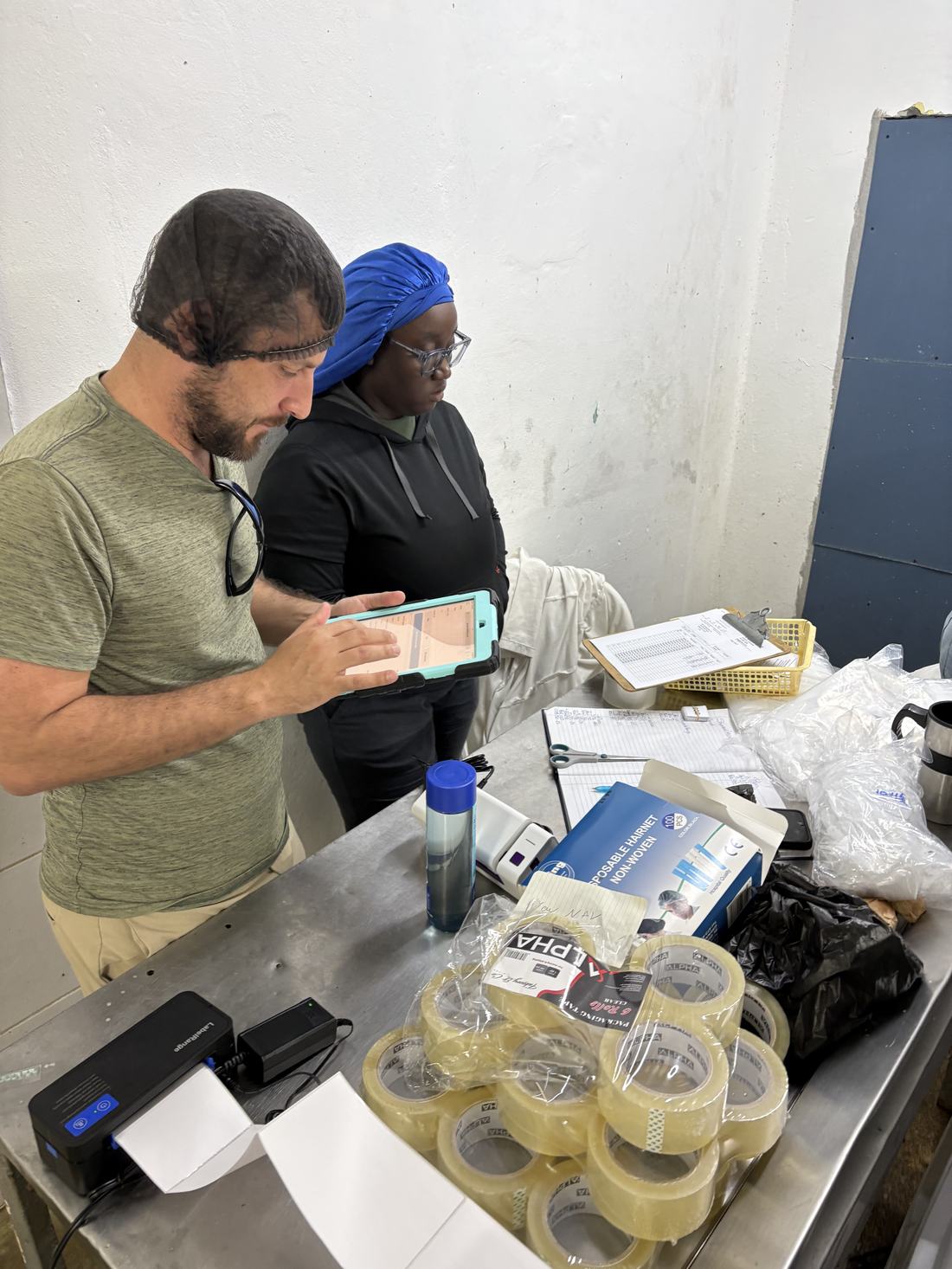 Nick Bernal at the packing bench with a tablet